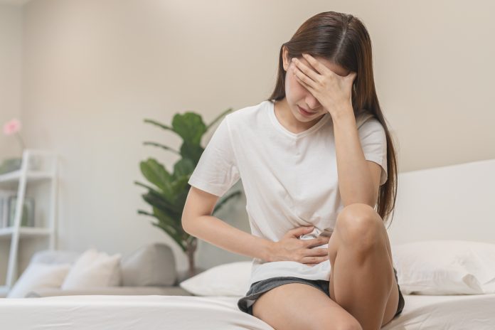 Flatulence ulcer, asian young woman, girl hands in belly, stomachache from food poisoning, abdominal pain and digestive problem, gastritis or diarrhoea. Abdomen inflammation, menstrual period people.